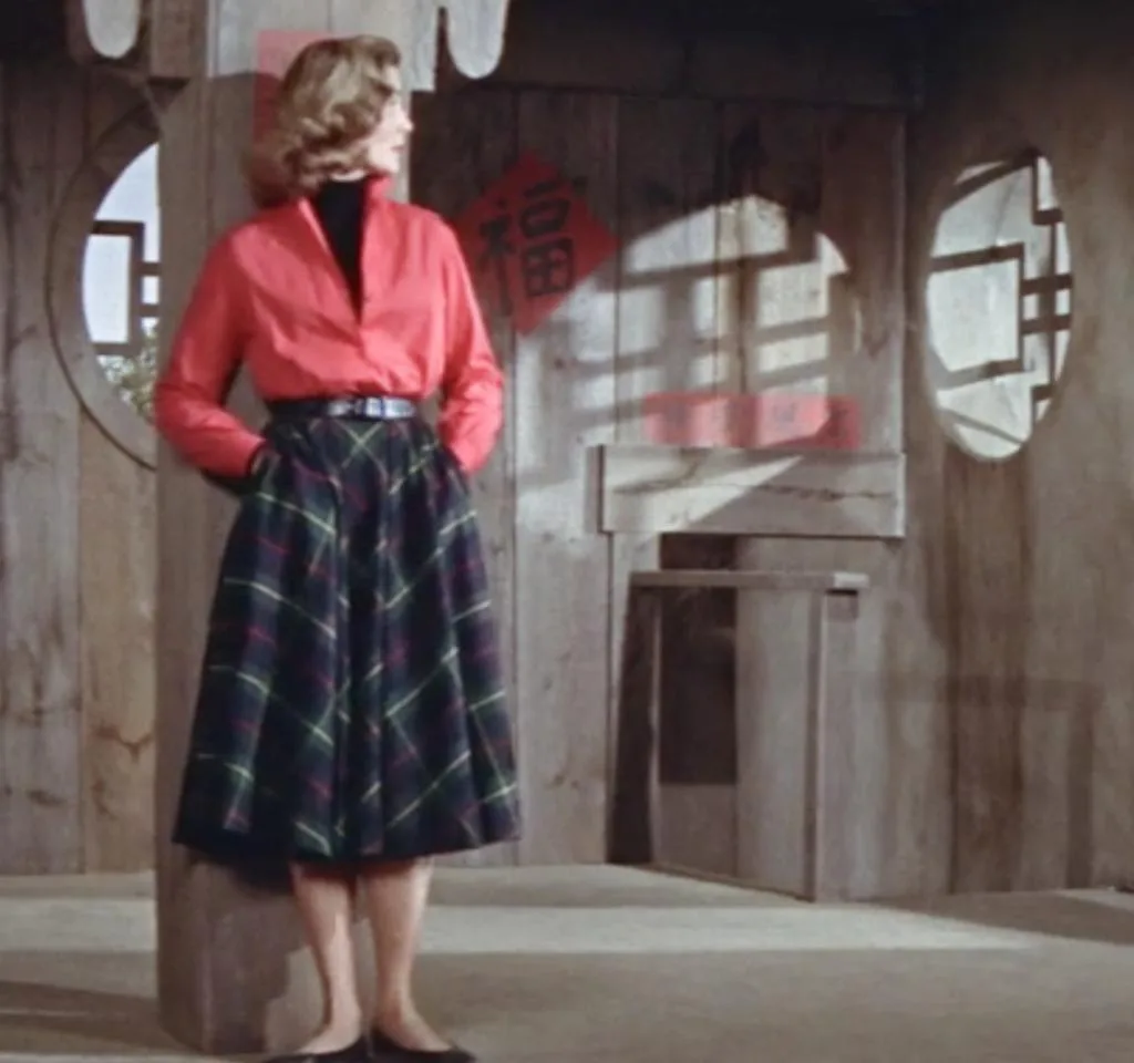 Image of Lauren Bacall wearing 1950s fashion in Blood Alley, 1955