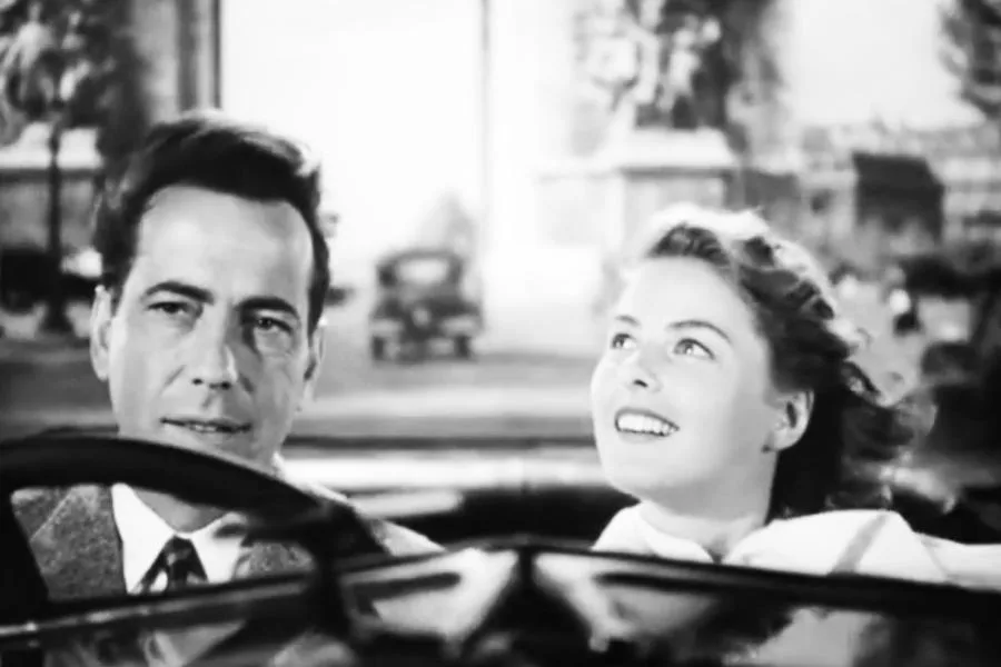 Ingrid Bergman and Humphrey Bogart wearing 1940s fashion while driving in Casablanca
