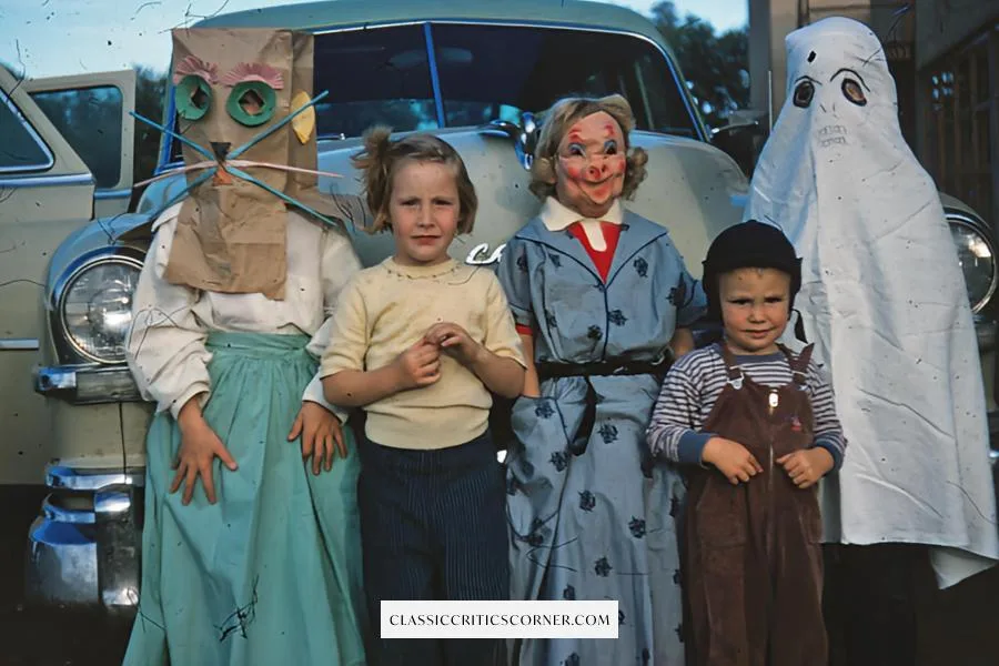 Image of four children standing in front of a vintage car in the 1950s, wearing homemade costumes for 1950s Halloween Trick or Treat